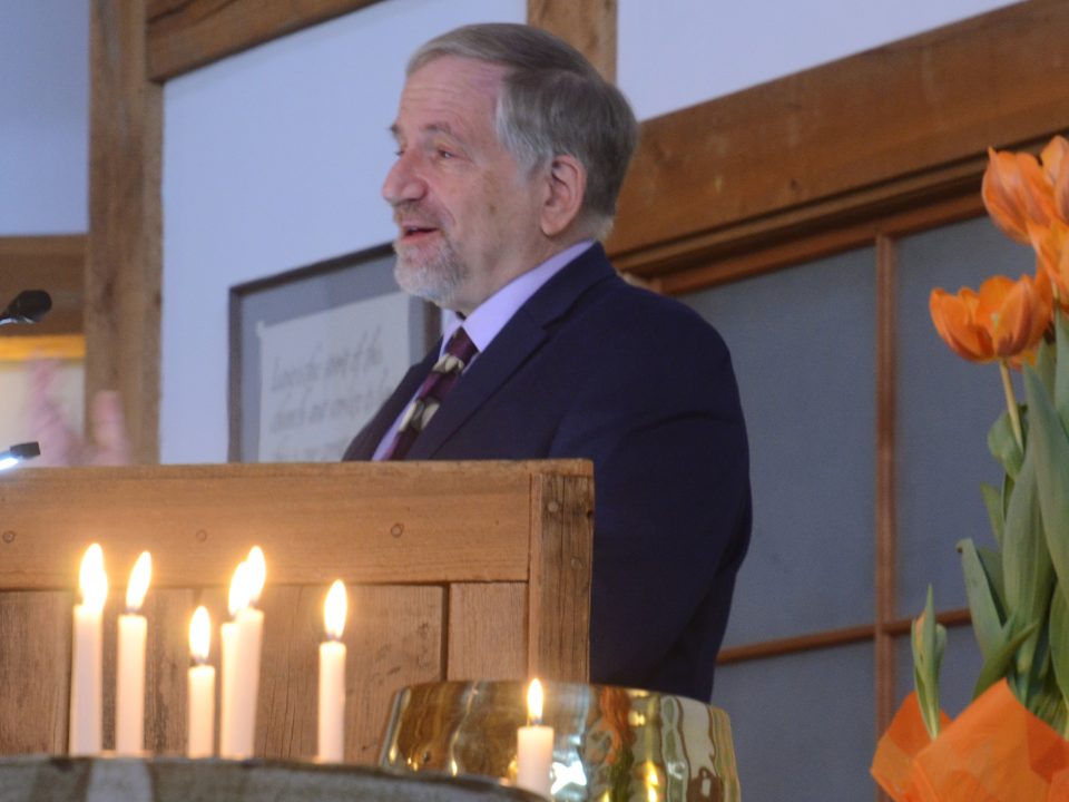 Picture of Rev. Dr. Tony Larsen standing at the lectern.